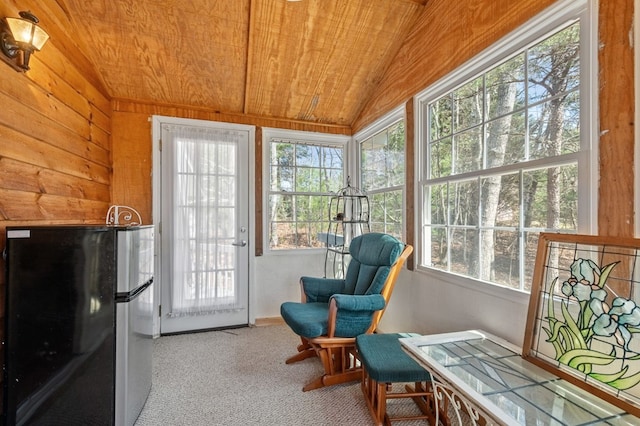 sunroom / solarium with wood ceiling, lofted ceiling, and a wealth of natural light