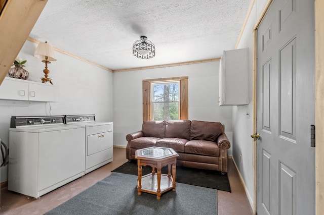 living room with concrete floors, ornamental molding, independent washer and dryer, and a textured ceiling