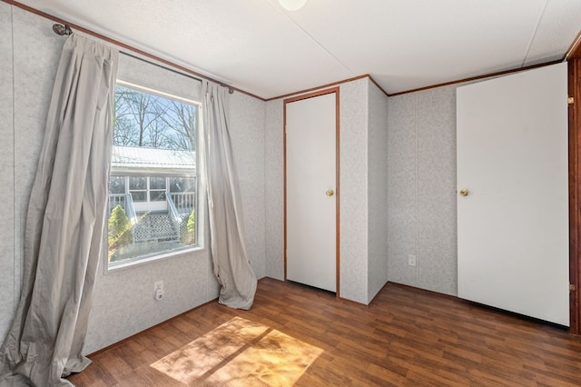 empty room featuring a textured ceiling and hardwood / wood-style flooring