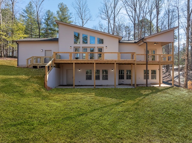 rear view of property with a lawn and a wooden deck