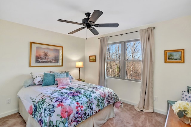 bedroom with ceiling fan and light carpet