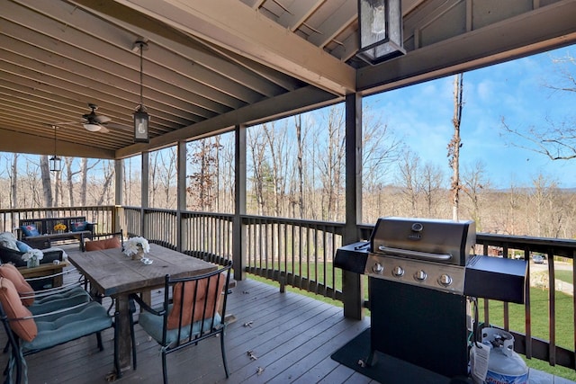 deck with grilling area and ceiling fan