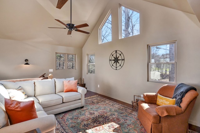 living room featuring hardwood / wood-style floors, ceiling fan, and high vaulted ceiling