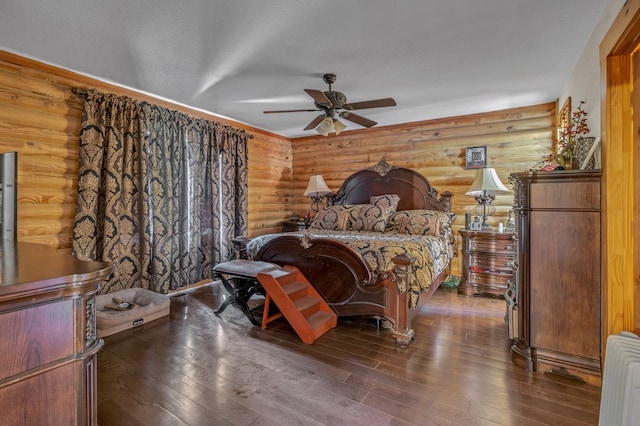 bedroom featuring dark wood-type flooring, ceiling fan, radiator, and a textured ceiling