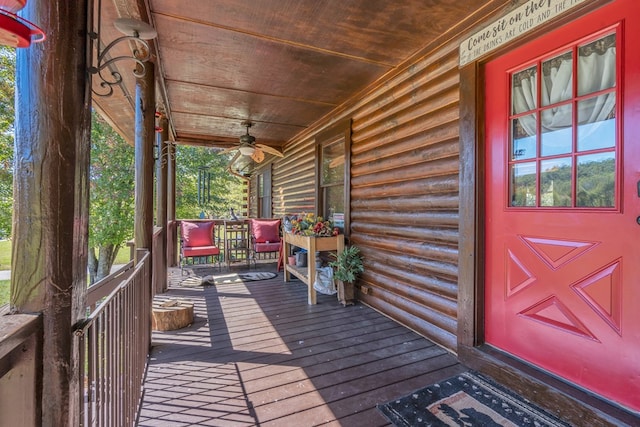 wooden deck featuring a porch and ceiling fan