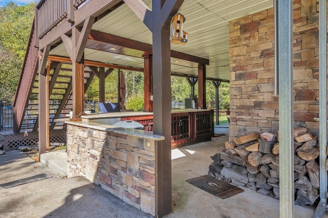 view of patio with exterior kitchen and an outdoor bar