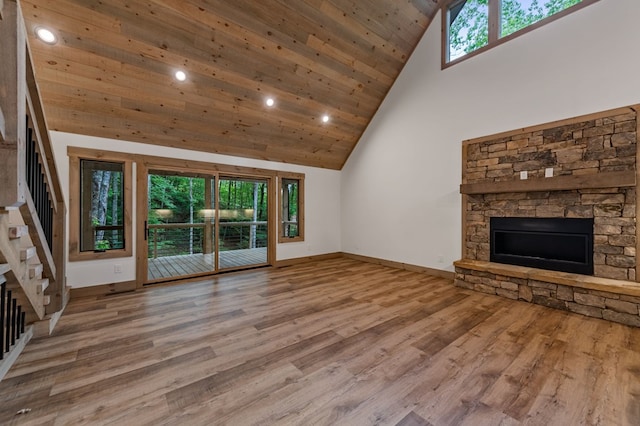 74 Cohutta Overlook Way, Blue Ridge, GA 30513 - unfurnished living room with high vaulted ceiling, a stone fireplace, plenty of natural light, stairs, and recessed lighting