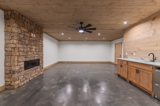 74 Cohutta Overlook Way, Blue Ridge, GA 30513 - unfurnished living room featuring a sink, finished concrete floors, wood ceiling, a stone fireplace, and a ceiling fan