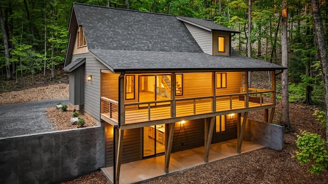74 Cohutta Overlook Way, Blue Ridge, GA 30513 - back of house featuring roof with shingles, a forest view, and a patio area