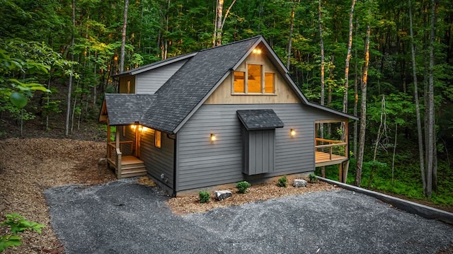 74 Cohutta Overlook Way, Blue Ridge, GA 30513 - chalet / cabin with roof with shingles, a view of trees, and covered porch
