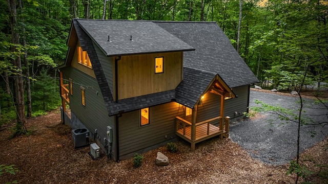 74 Cohutta Overlook Way, Blue Ridge, GA 30513 - rustic home featuring a shingled roof, central AC, and a view of trees