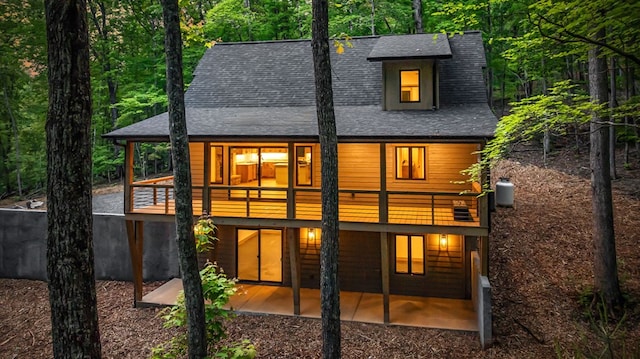 74 Cohutta Overlook Way, Blue Ridge, GA 30513 - back of property featuring a shingled roof, a patio area, and a balcony