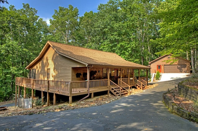 191 Deer Run Rd, Blairsville, GA 30512 - view of front of house with an outbuilding, a porch, a detached garage, and roof with shingles