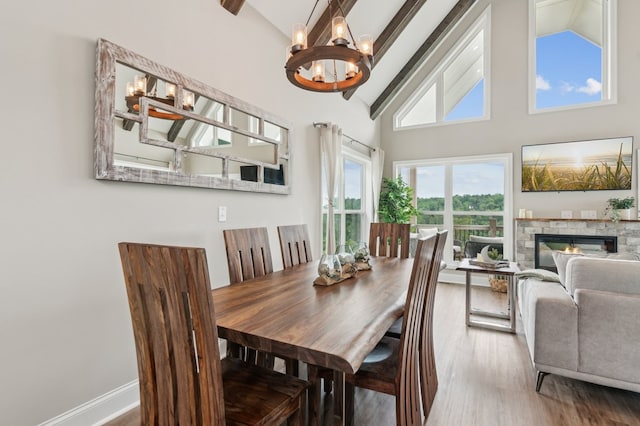 497 S Jakes Landing Way, Ellijay, GA 30540 - dining area with a chandelier, beamed ceiling, high vaulted ceiling, wood finished floors, and a fireplace