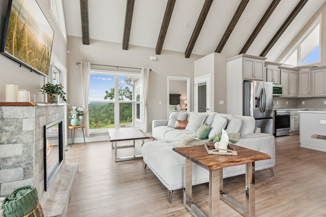 497 S Jakes Landing Way, Ellijay, GA 30540 - living area featuring a fireplace, high vaulted ceiling, light wood-style floors, beam ceiling, and plenty of natural light