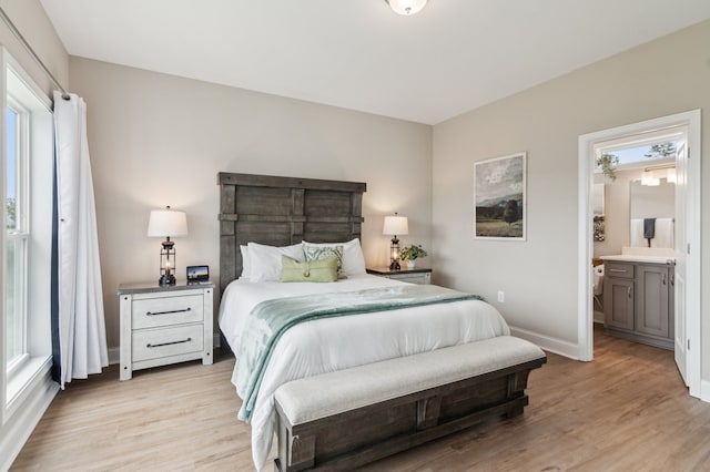 497 S Jakes Landing Way, Ellijay, GA 30540 - bedroom with light wood-type flooring, multiple windows, baseboards, and ensuite bathroom