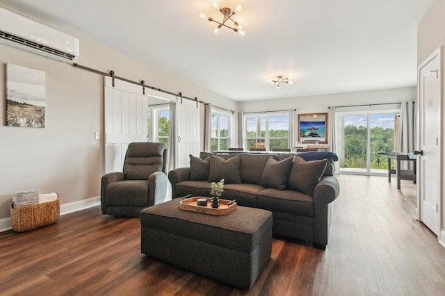 497 S Jakes Landing Way, Ellijay, GA 30540 - living room with an AC wall unit, dark wood finished floors, a barn door, baseboards, and a chandelier
