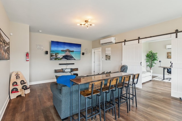 497 S Jakes Landing Way, Ellijay, GA 30540 - living area with a barn door, a wall mounted air conditioner, wood finished floors, and baseboards