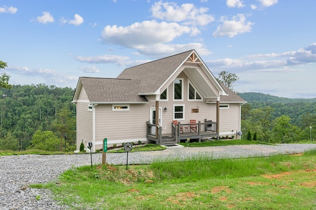 497 S Jakes Landing Way, Ellijay, GA 30540 - view of front of home with a forest view, a deck, roof with shingles, and driveway