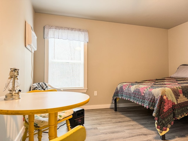 bedroom featuring baseboards and light wood-style floors