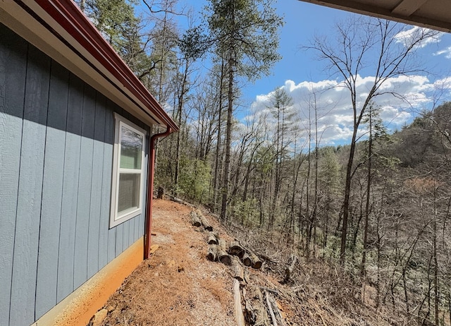 view of yard with a forest view