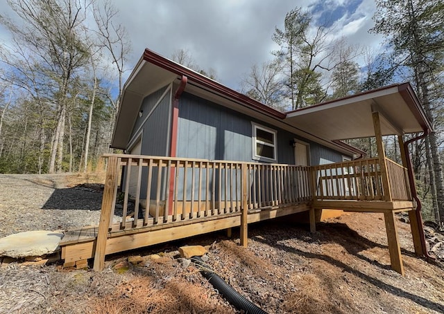 view of side of property featuring a wooden deck