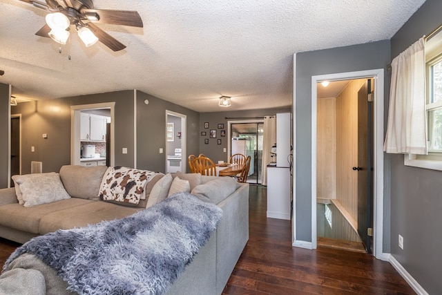 1214 Marrestop Rd, Murphy, NC 28906 - living room featuring dark wood-style flooring, a ceiling fan, a textured ceiling, and baseboards