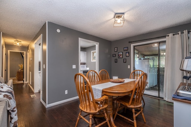 1214 Marrestop Rd, Murphy, NC 28906 - dining space with a textured ceiling, dark wood-style floors, and baseboards