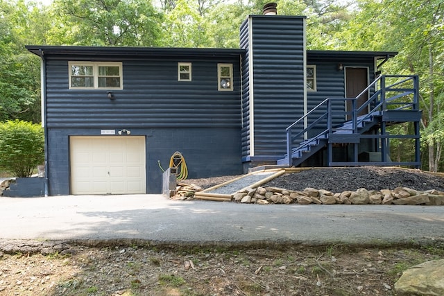 1214 Marrestop Rd, Murphy, NC 28906 - view of front of home with stairway, a chimney, asphalt driveway, faux log siding, and a garage