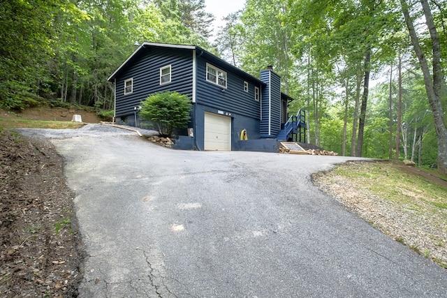 1214 Marrestop Rd, Murphy, NC 28906 - view of side of property with a chimney, driveway, and an attached garage