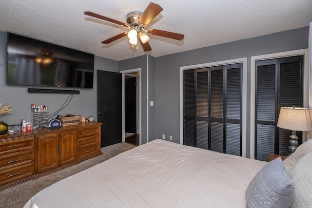 1214 Marrestop Rd, Murphy, NC 28906 - carpeted bedroom featuring multiple closets, a textured ceiling, and ceiling fan