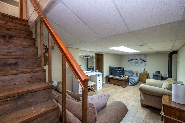 1214 Marrestop Rd, Murphy, NC 28906 - living room with a wood stove, stairway, wood finished floors, and a paneled ceiling
