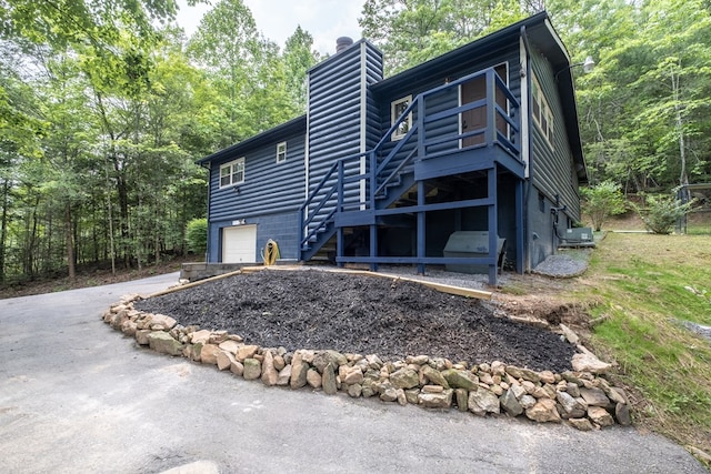 1214 Marrestop Rd, Murphy, NC 28906 - view of front of home with stairs, a chimney, a garage, asphalt driveway, and a view of trees