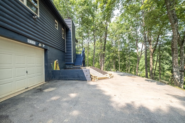 1214 Marrestop Rd, Murphy, NC 28906 - view of property exterior featuring driveway, stairs, a chimney, and an attached garage