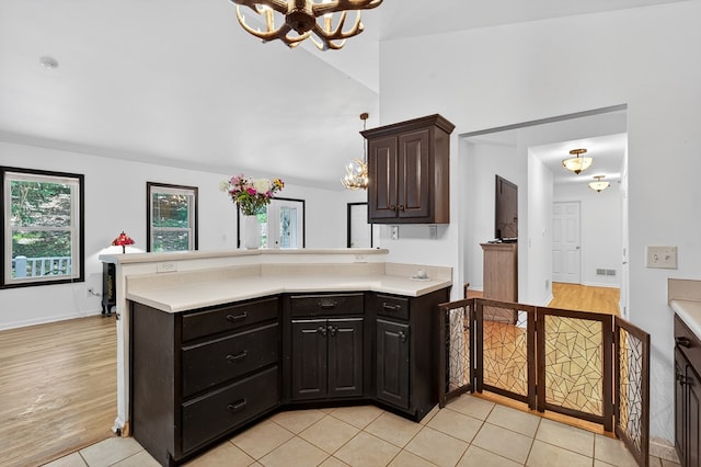 2790 Tamarack Dr, Jasper, GA 30143 - kitchen featuring a chandelier, light countertops, a peninsula, and light tile patterned floors