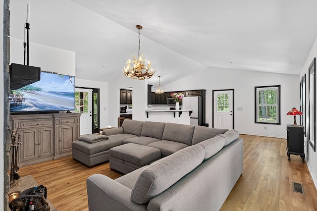 2790 Tamarack Dr, Jasper, GA 30143 - living area with lofted ceiling, light wood finished floors, and a chandelier