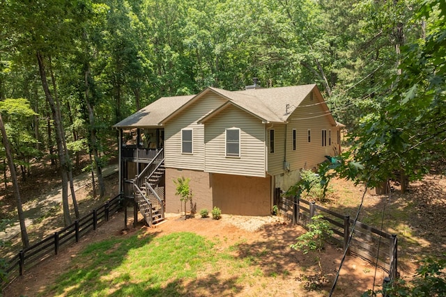 2790 Tamarack Dr, Jasper, GA 30143 - view of side of home featuring stairs, a fenced backyard, a forest view, and a shingled roof