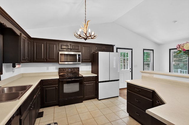 2790 Tamarack Dr, Jasper, GA 30143 - kitchen featuring black range with electric cooktop, stainless steel microwave, freestanding refrigerator, a chandelier, and lofted ceiling