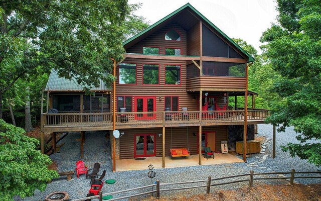 rear view of property with a wooden deck