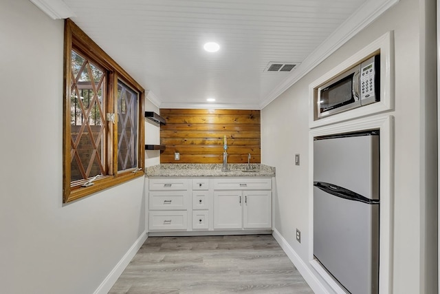 bathroom with crown molding and hardwood / wood-style floors