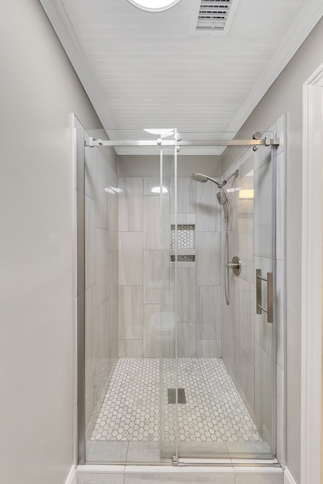 bathroom featuring an enclosed shower and crown molding