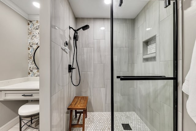 bathroom featuring a shower with door and crown molding