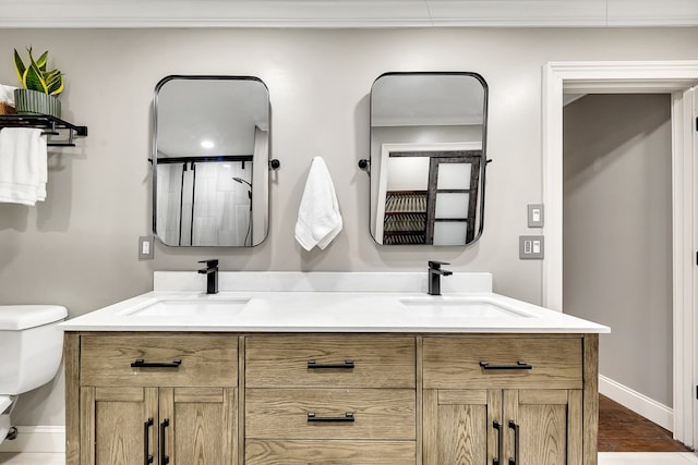 bathroom with toilet, vanity, and a shower with door