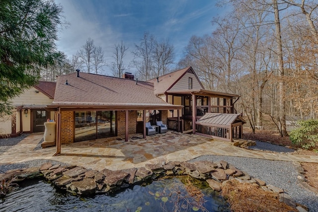 back of property with a patio