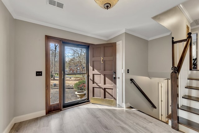 foyer with light hardwood / wood-style flooring and crown molding