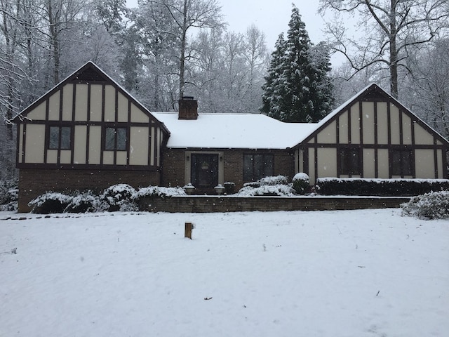 view of snow covered rear of property