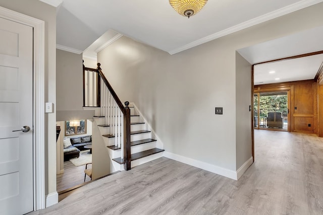 stairway featuring hardwood / wood-style flooring and ornamental molding