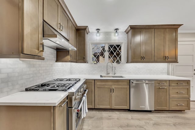 kitchen featuring light hardwood / wood-style floors, appliances with stainless steel finishes, tasteful backsplash, light stone countertops, and sink