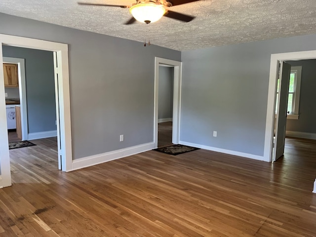 empty room with ceiling fan, a textured ceiling, and hardwood / wood-style floors