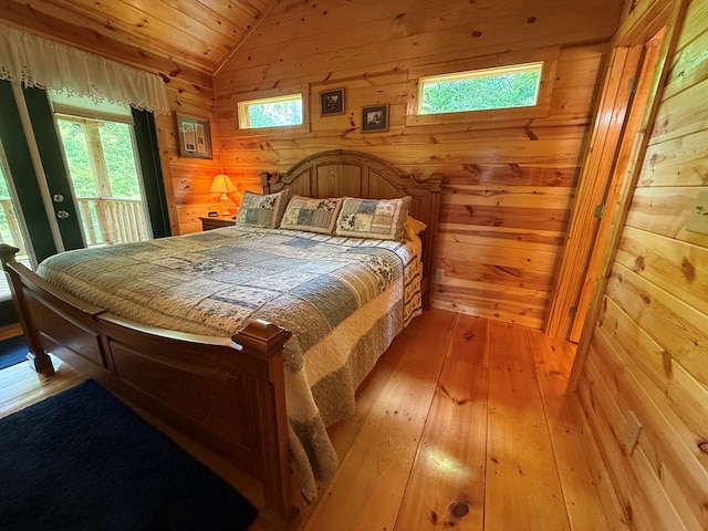 100 Bryant Farm Rd, Murphy, NC 28906 - bedroom with lofted ceiling, access to exterior, wood-type flooring, wood walls, and wooden ceiling